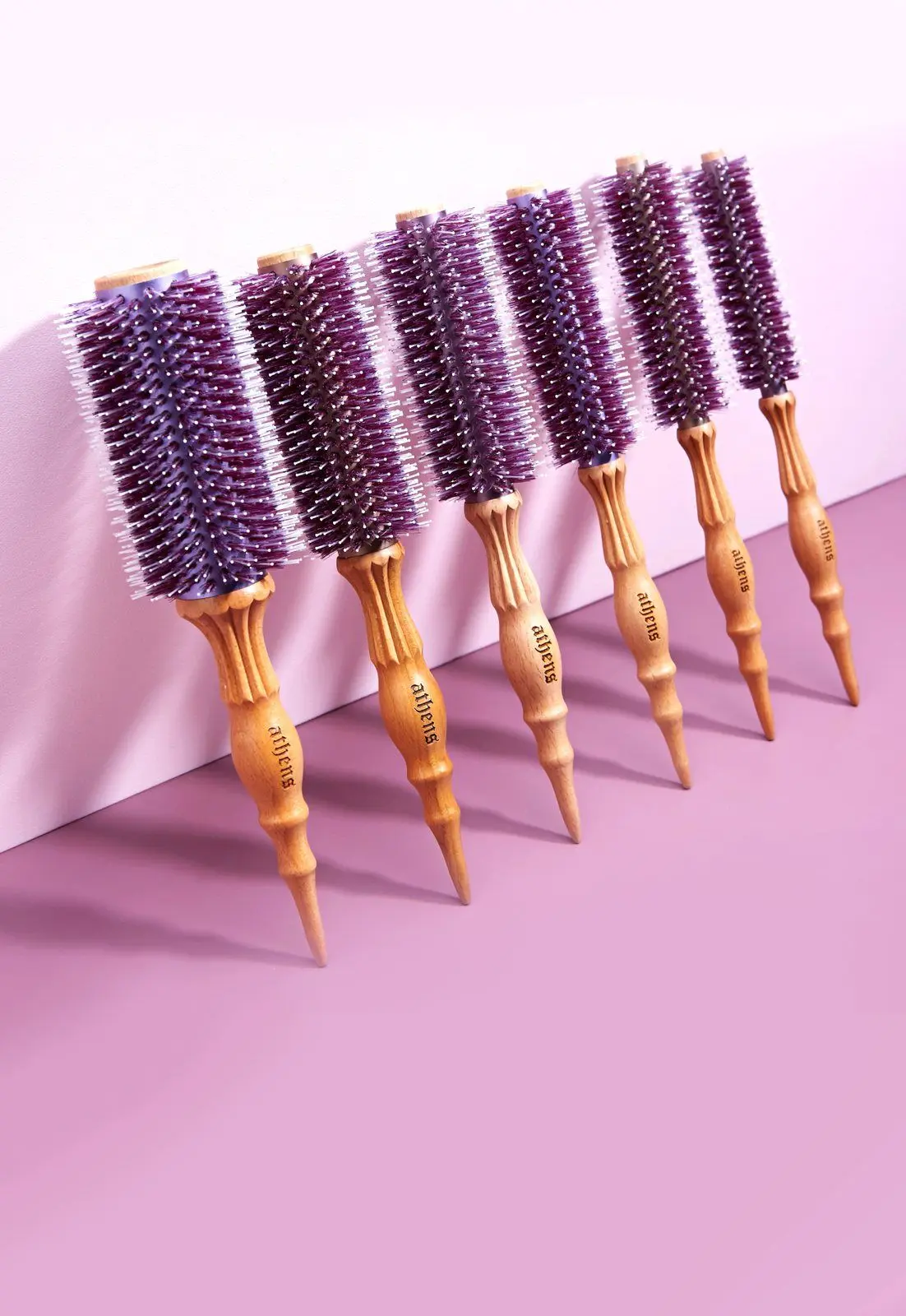 Athens Goddess Roll Brushes in a row against lilac