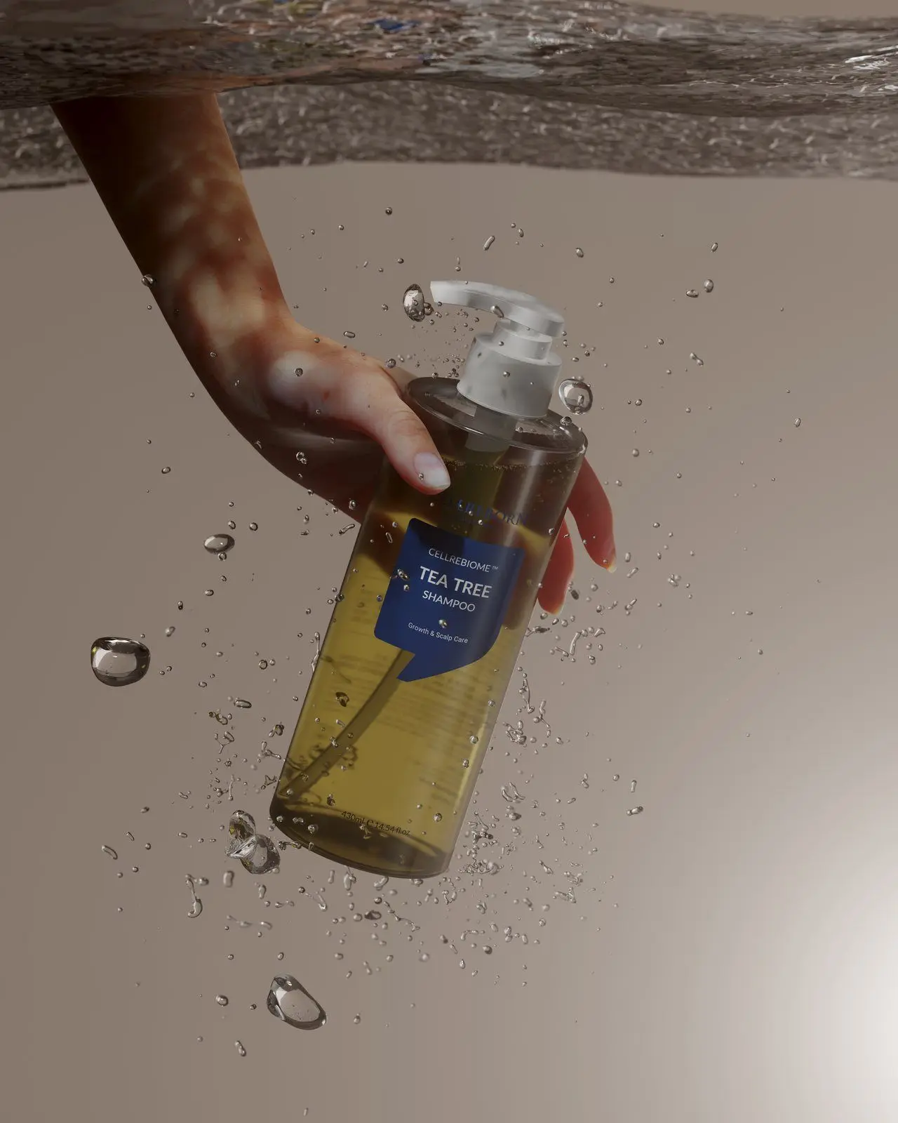 A hand holding a Cellrebiome Tea Tree Shampoo bottle under water with rising bubbles